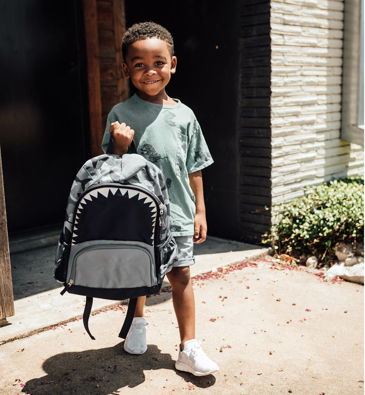 Cute kid holding a backpack